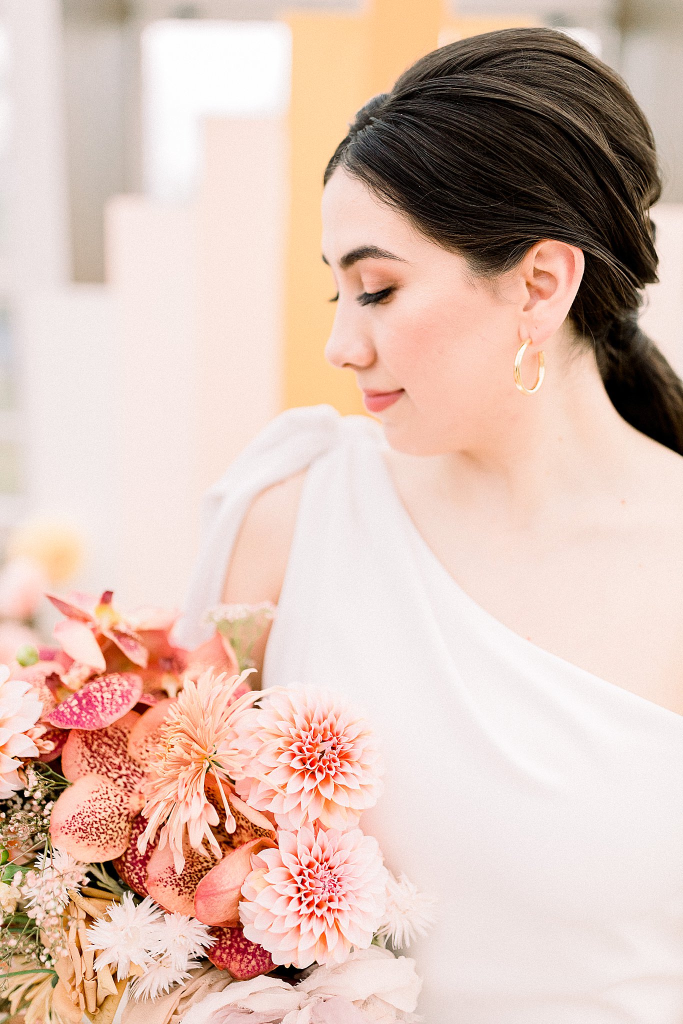 Bride posing with beautiful peach and pink bouquet