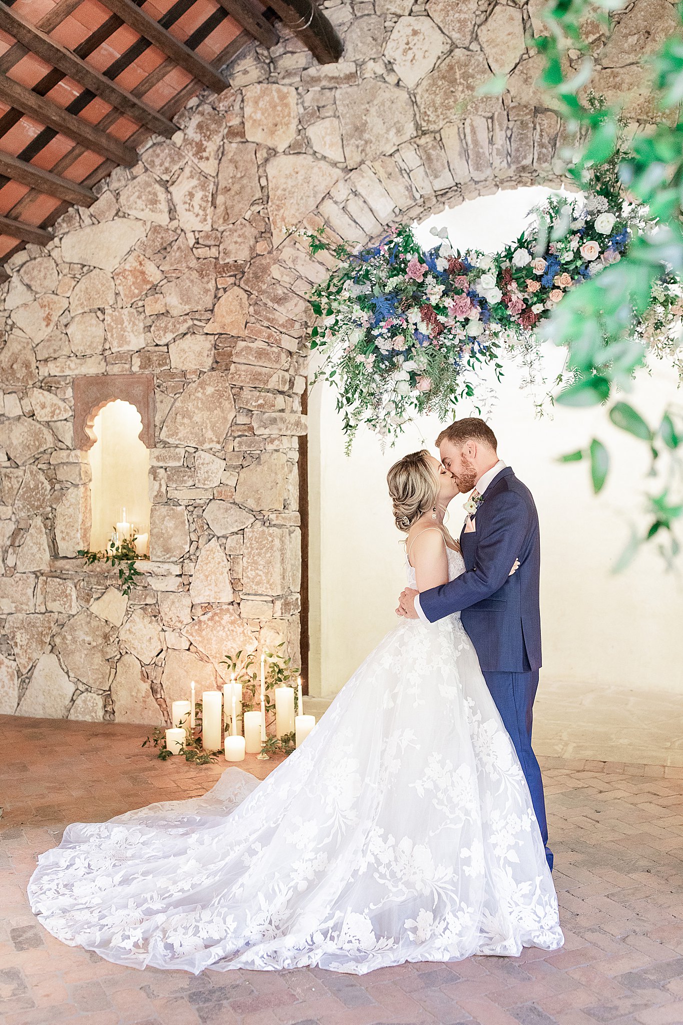 Stunning bride and groom at Camp Lucy, candlelight chapel, floral installment, stone walls